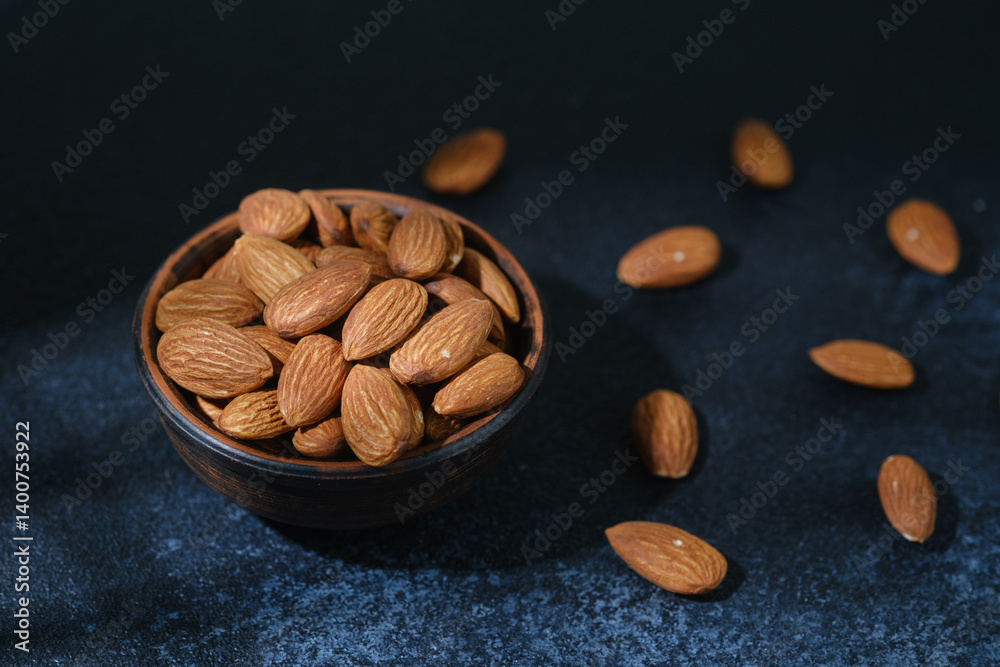 Top view of almonds in wooden bowl healthy food concept..