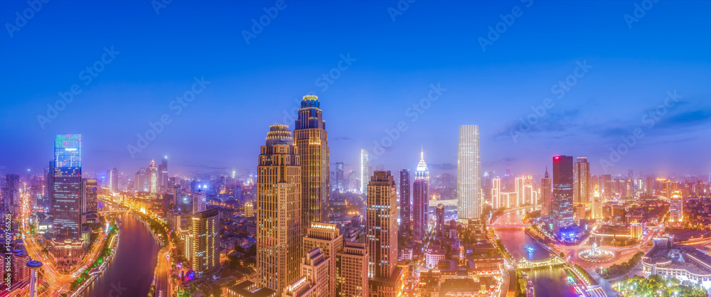 Obraz premium Stunning Nighttime Cityscape Panorama with Illuminated Skyscrapers