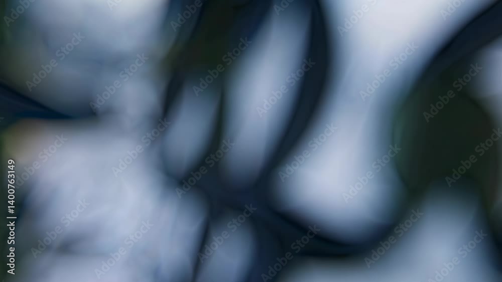Soft blurry light leaks through defocused natural background creating calming abstract bokeh effect in soft blue tones
