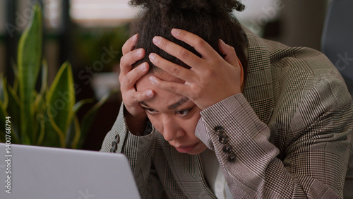 African American ethnic woman businesswoman employee business worker manager in office overtime online work exhausted tired sad girl lady female frustrated overworked fatigue headache problem laptop