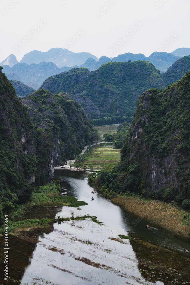 Stunning view from the Hang Múa Viewpoint with the a dramatic landscape and the Tam Coc river in the distance. Ninh Binh, Vietnam.