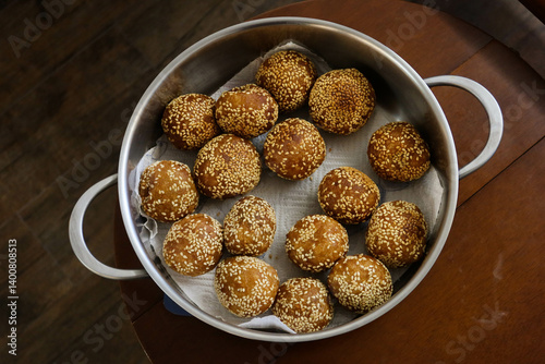 close up of many Chinese traditional festival snacks deep fried Sesame Ball (Jiandui) stuffed with sweet potato and red bean billing for Lunar New Year in the pot