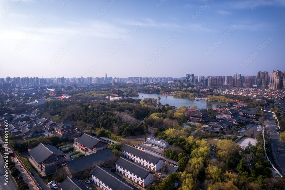 Obraz premium Aerial View of a Modern City Surrounded by Nature and Water