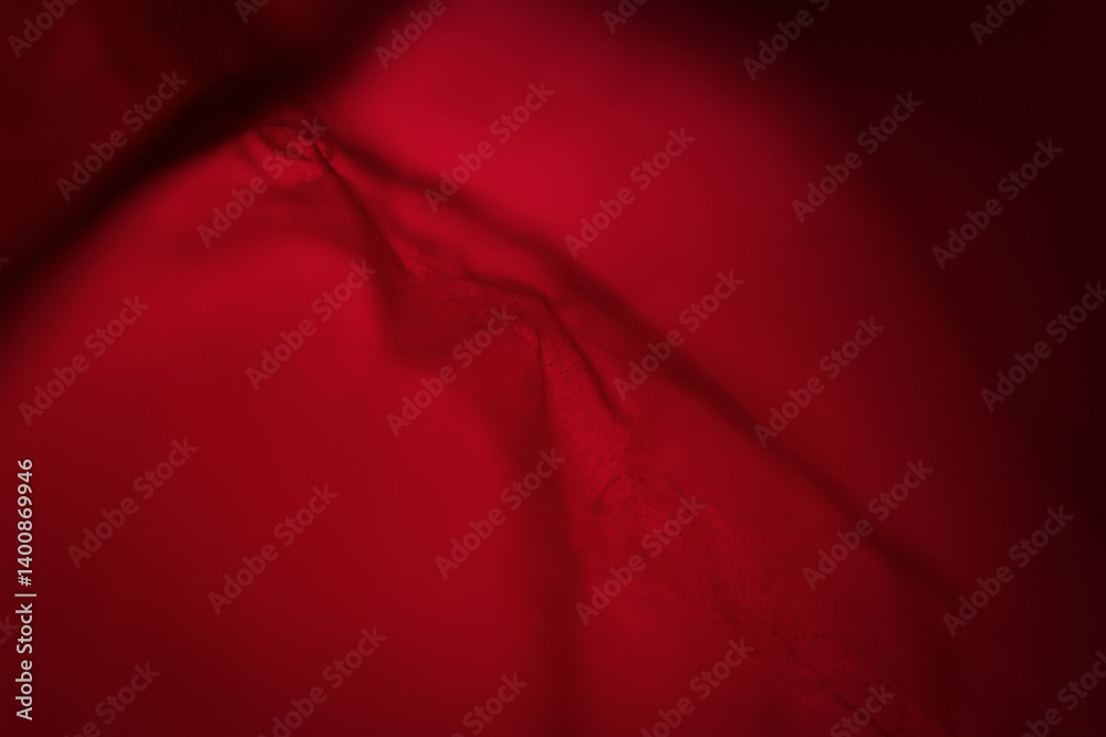 Extreme close up of red empty plastic bag background. The plastic surface is wrinkly and tattered making abstract pattern. Selective focus, shallow depth of field.