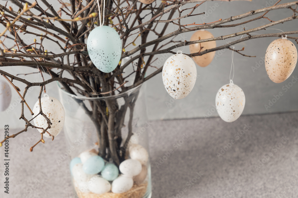 Easter tree decorated colorful pastel white and beige eggs. Birch branches with hang eggs in vase. Happy Easter greeting card. Close up