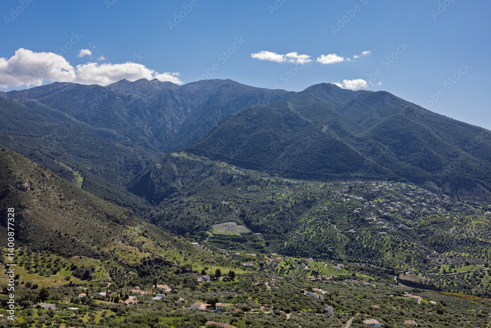 Naklejka premium Impressive mountain range dominating picturesque valley in crete, greece