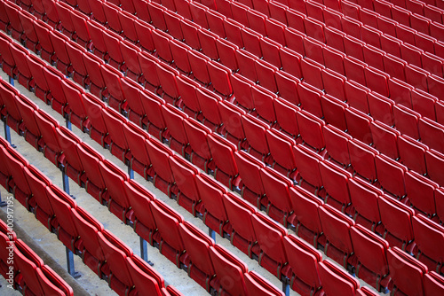 The empty seats in the stadium are red and arranged in rows