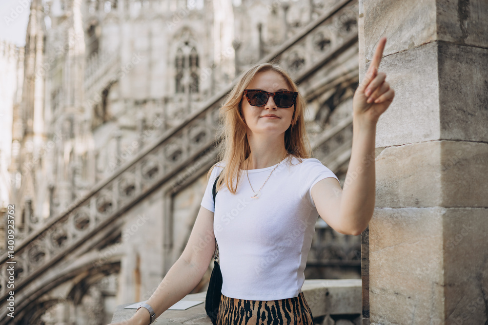 Female traveler standing on the rooftop of Duomo cathedral in Milan. Having great vacations in Milan