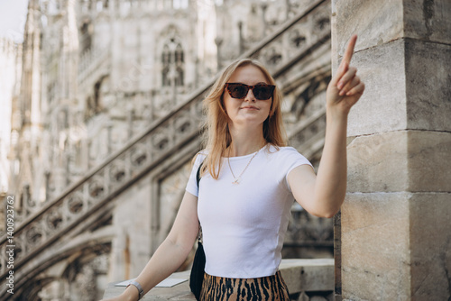 Female traveler standing on the rooftop of Duomo cathedral in Milan. Having great vacations in Milan