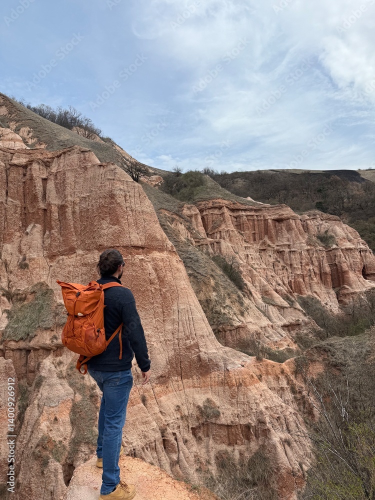 Hiker Overlooking the Red Ravines of Râpa Roșie, Romania