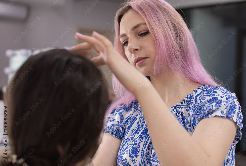 Fototapeta premium makeup artist applying face powder on beautiful model