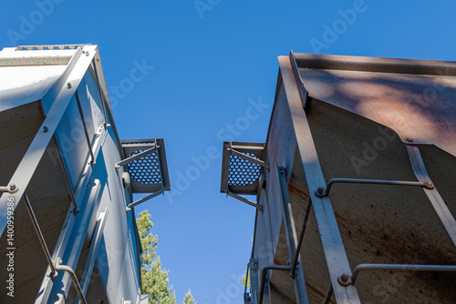 The tops of two railroad freight cars that are coupled together