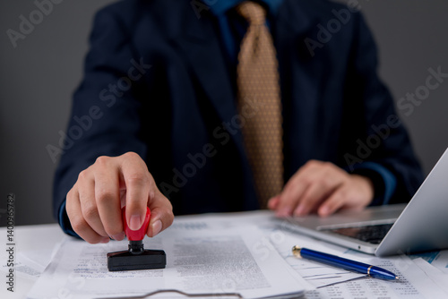 Quadro em tela Businessman stamping official documents for approval