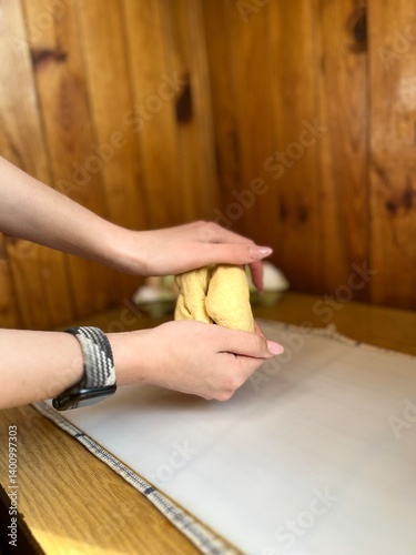 close up of a woman hands kneading dough