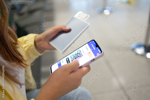 Obraz na płótnie Close up hand of black businesswoman checking flight eticket on phone while holding passport and boarding pass. African american woman hand checking online travel plane ticket on mobile phone. High w salonie