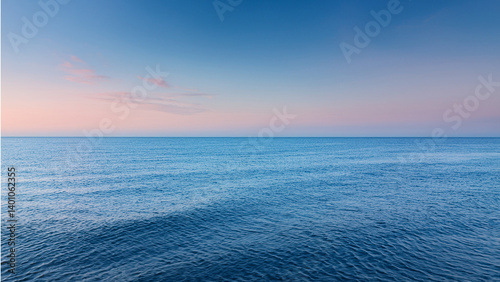 Serene sunset over the ocean with minimal wave movement
