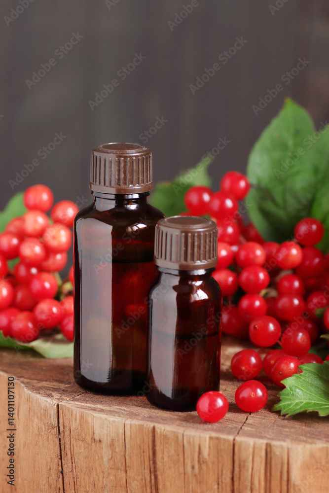 Guelder Rose juice or oil with red berries on wooden rustic background, natural medicine conceptр Guelder Rose juice or oil with red berries on wooden rustic background, natural medicine conceptр