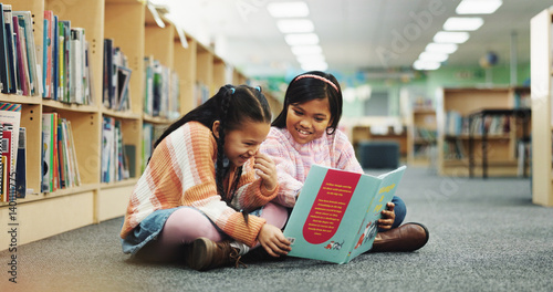 Girl, together and happy with book at library for development, learning and study on floor. School kids, storytelling and excited with scholarship, education and language with reading at academy