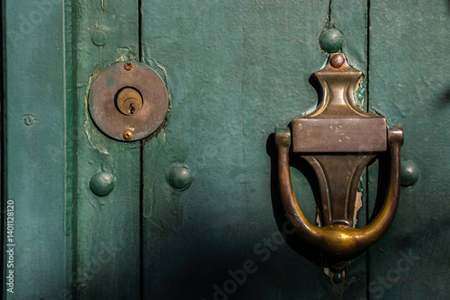 Old wooden doors with an old metal door handle knocker in Brazil
