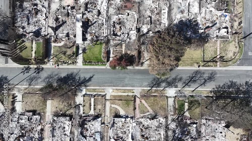 Top down aerial view LA fires with burnt and destroyed homes in Pacific Palisades neighborhood in Los Angeles, California.