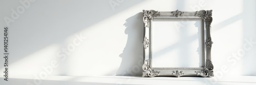 Ornate silver photo frame casts shadow, clean white wall, minimal, silver, detail