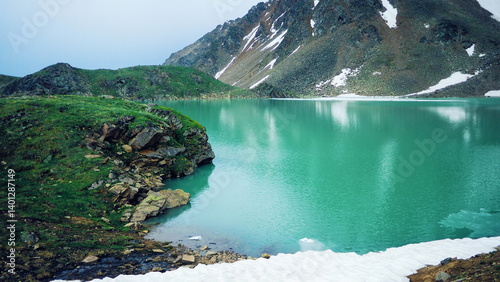 Emerald-turquoise mountain glacial lake Syltrankel in summer. Elbrus National Park. Caucasus.