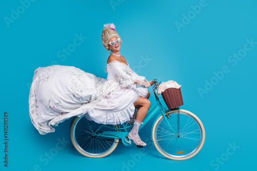Elegant woman in vintage baroque attire riding a bicycle against a bright blue background with vibrant and playful styling