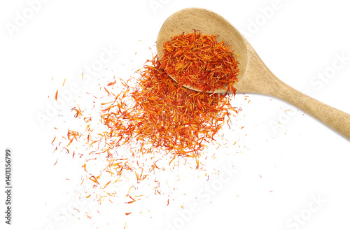 Fototapeta Naklejka Na Ścianę i Meble -  Safflower dry petals, exotic spice in wooden spoon flying isolated on white