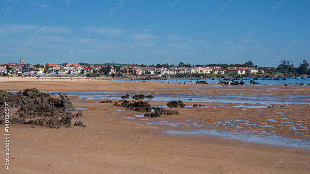 Trengandin beach with sand and black rocks in the town of Noja in Cantabria, Spain Trengandin beach with sand and black rocks in the town of Noja in Cantabria, Spain