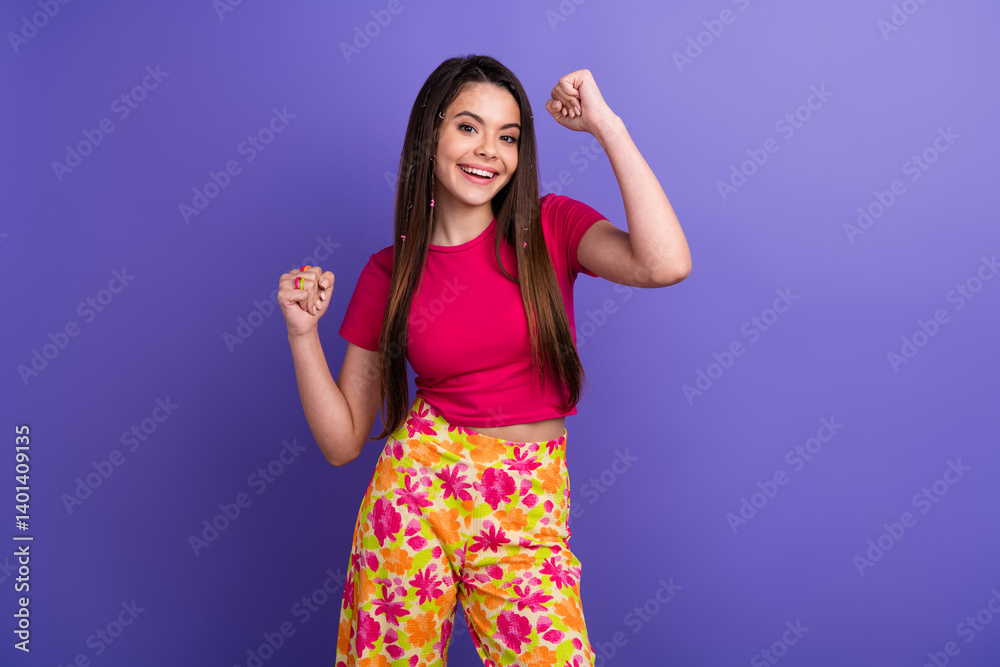 Fototapeta premium Cheerful young woman in stylish outfit smiling on colorful background demonstrating vibrant style and positive energy in vibrant clothing
