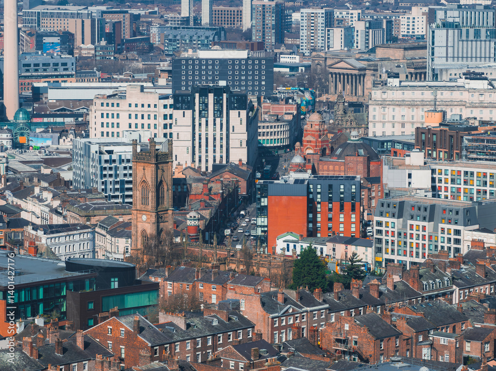 Aerial view of Liverpool showcasing St. Luke's Church, St. George's Hall, Radio City Tower, red brick houses, and modern architecture.