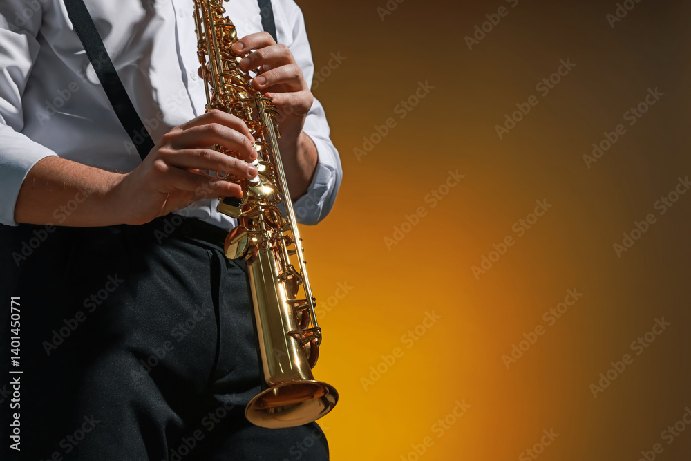 Naklejka premium Professional musician playing soprano saxophone on color background, closeup. Space for text