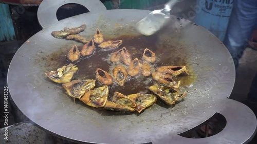 Hilsha fish is fried in a big pan along with shrimp and eggplant, Hilsha Fish and shrimp Simmering in mustard oil, traditional Bengali style fried hilsa and eggplant	