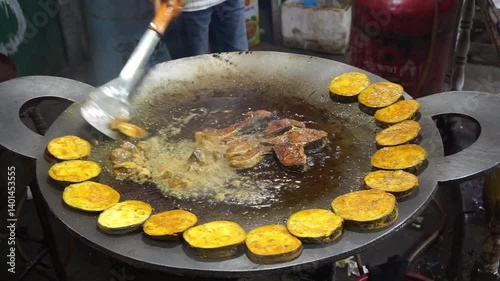Hilsha fish is fried in a big pan along with shrimp and eggplant, Hilsha Fish and shrimp Simmering in mustard oil, traditional Bengali style fried hilsa and eggplant	
