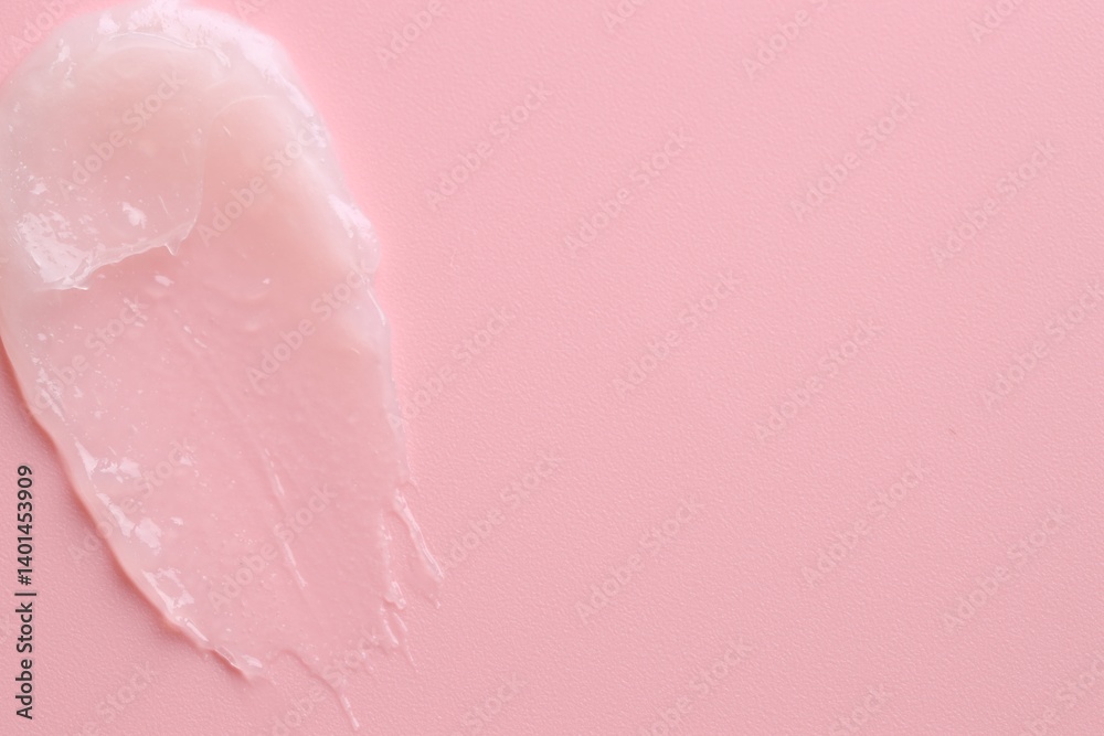 Fototapeta premium Moisturizing lip balm on pink background, top view. Space for text