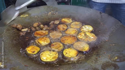 Hilsha fish is fried in a big pan along with shrimp and eggplant, Hilsha Fish and shrimp Simmering in mustard oil, traditional Bengali style fried hilsa and eggplant	