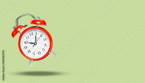Obraz na płótnie Red alarm clock ringing and jumping on sage color background. Banner design with space for text w salonie