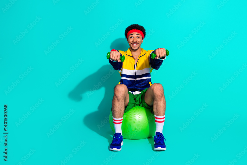 Fototapeta premium Young man exercising with retro style activewear on a teal background, featuring vibrant colors