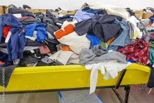 Store bin filled with disorganized jumble of clothes