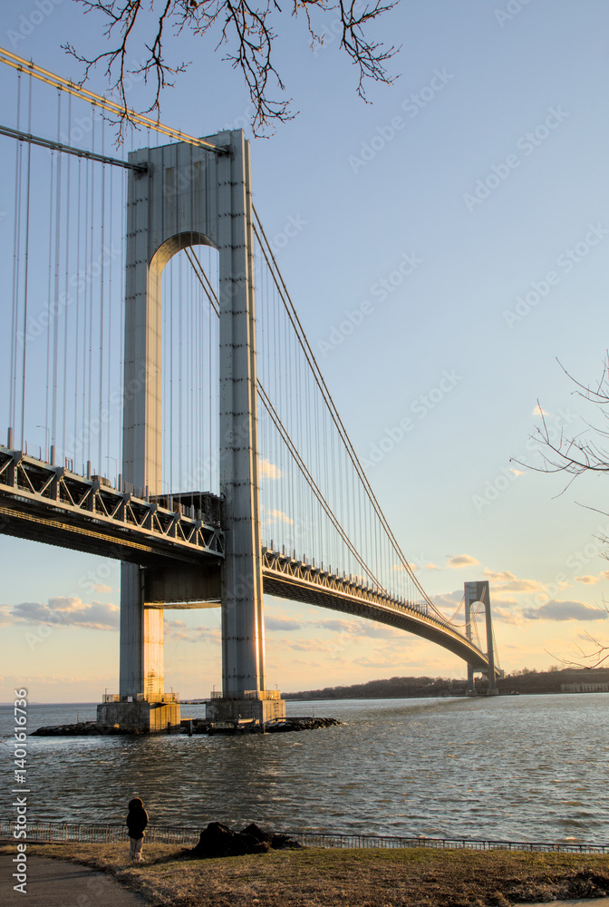 Naklejka premium view of verrazzano bridge with water in river at new york city harbor (suspension structure between bay ridge brooklyn and staten island) nyc landmark sunset cloudy vista tourism travel