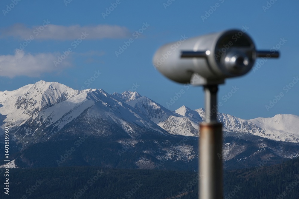 Viewpoint Pass over Lapszanka with snow-capped peaks of High Tatras and Bialskie Tatras mountains and blurred binoculars in foreground, Poland