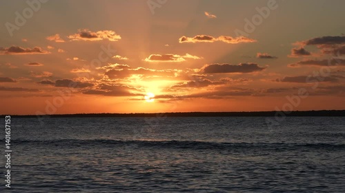 Tropical Sunset Casting Rays Across Open Sea