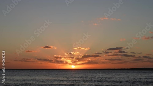 Wide Slow Pan of Sunset Over Calm Ocean