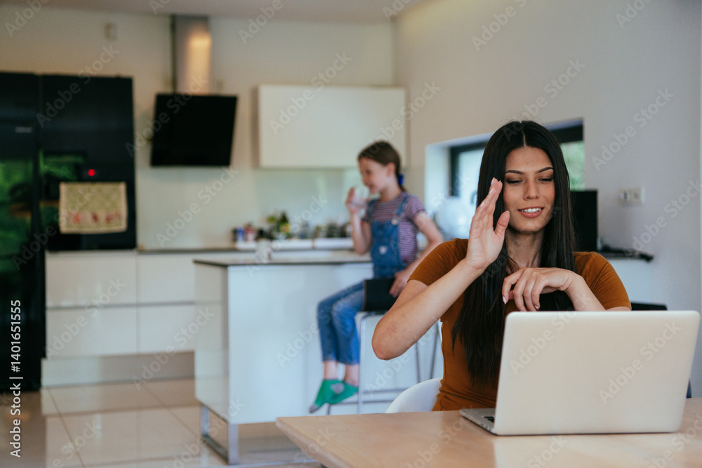 Mother with her daughter talking on laptop with family and friends while sitting in modern living room of big house.