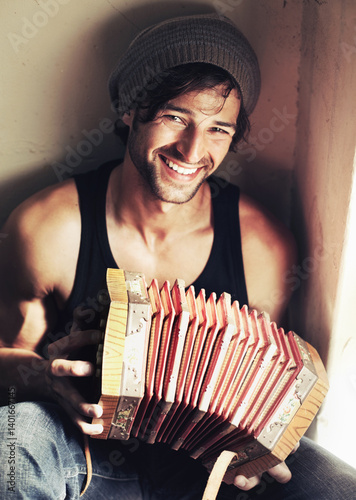 Portrait, happy man and musician with smile for accordion for music, love or hobby in room. Young person, instrument or practice by joyful expression on face for play, entertainment or performance