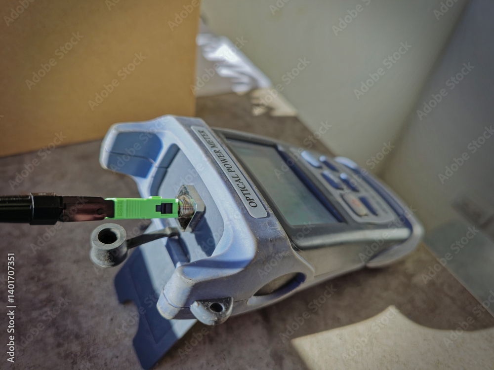 Optical power meter measuring light level of fiber optic cable Optical power meter measuring light level of fiber optic cable
