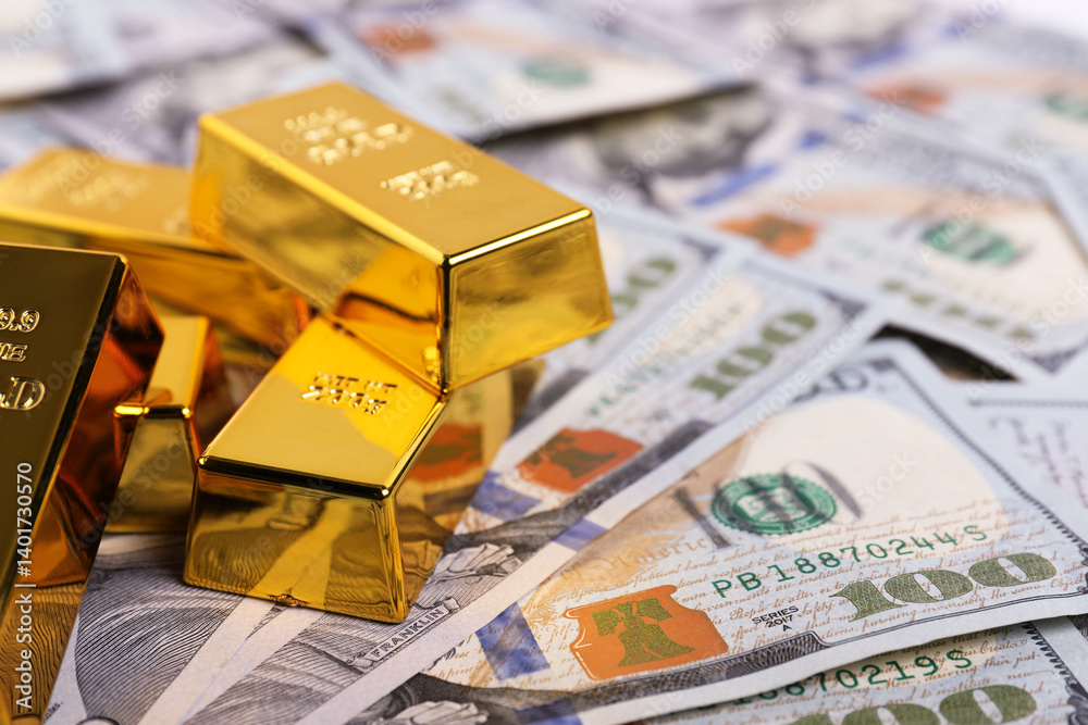 Shiny gold bars on dollar banknotes, closeup. Space for text Shiny gold bars on dollar banknotes, closeup. Space for text