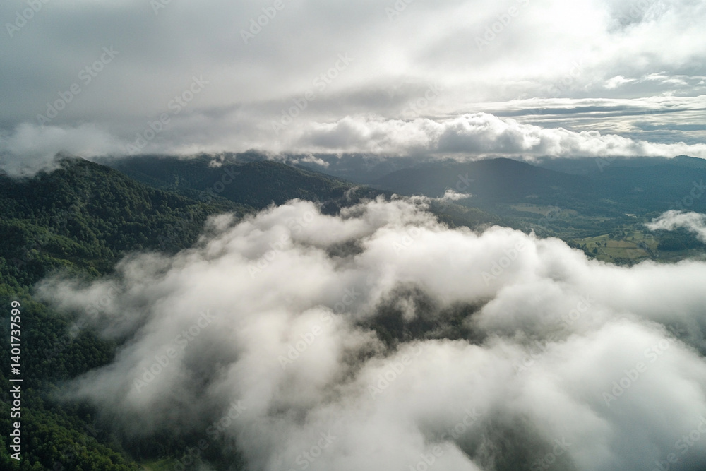 Majestic view of rolling clouds over lush green mountains during early morning light Majestic view of rolling clouds over lush green mountains during early morning light