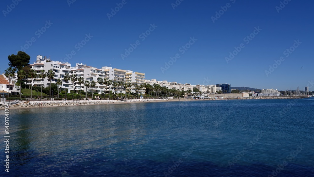 Estepona beach reflecting on calm mediterranean sea under blue sky in Marbella Spain Estepona beach reflecting on calm mediterranean sea under blue sky in Marbella Spain