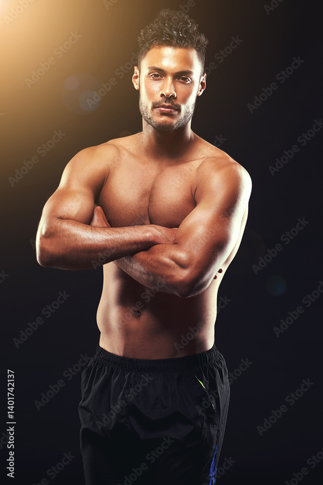 Fototapeta premium Fitness, portrait and man in studio with pride, confidence and workout routine in health, wellness and power. Arms crossed, muscle and strong athlete on black background for exercise, flare. and care